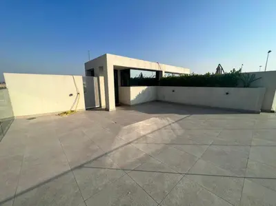 a building with a large patio in front of it at Room for rent in a luxury villa in Dubai
