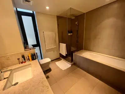 a bathroom with a tub and a sink and a toilet at Room for rent in a luxury villa in Dubai