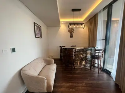 a living room with a couch and a table with chairs at Room for rent in a luxury villa in Dubai