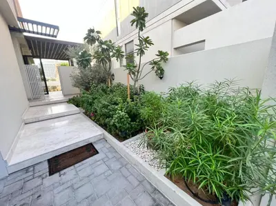 a courtyard of a building with plants and a staircase at Room for rent in a luxury villa in Dubai