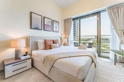 a bedroom with a large bed and a large window at Close to Meydan Racecourse and Ras Al Khor Wildlife Sanctuary, And a Quick Drive to Downtown Dubai and the Iconic Burj Khalifa - Azizi Riviera 44, Meydan by Deluxe Holiday Homes in Dubai