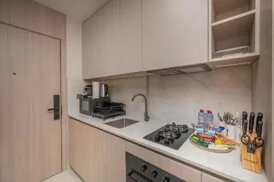 a kitchen with a stove and a counter top at Modern Studio Apartment for Rent Fully Furnished in Dubai