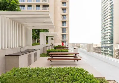 a row of benches on a balcony with a building at Elegant 1BHK Dubai Private Beachfront in Dubai