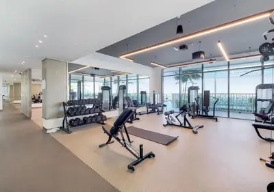 a gym with treadmills and exercise equipment in a building at Elegant 1BHK Dubai Private Beachfront in Dubai