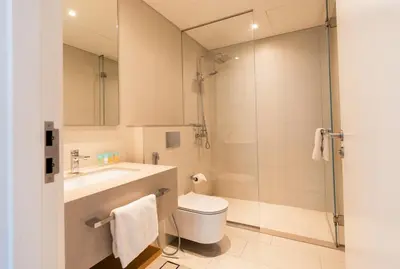 a bathroom with a shower and a toilet and a sink at Magical La Vie JBR Apt with Private Beach Access in Dubai