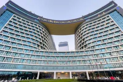 a large building with a lot of windows at Seven Palm Studio - Direct Beach Access- Rooftop Infinity Pool in Dubai