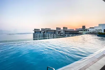 a large swimming pool on the roof of a building at Seven Palm Studio - Direct Beach Access- Rooftop Infinity Pool in Dubai