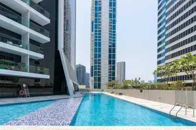 a swimming pool in the middle of a building with tall buildings at GuestReady - Canal View Studio | Near Downtown in Dubai