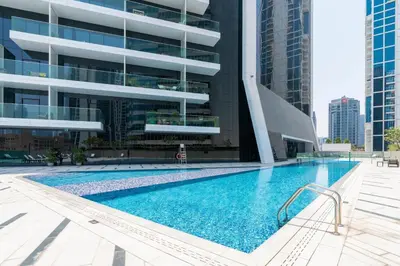 a swimming pool in front of a building at GuestReady - Canal View Studio | Near Downtown in Dubai