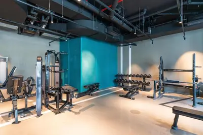 a gym with lots of equipment in a room at GuestReady - Canal View Studio | Near Downtown in Dubai