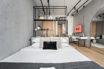 a bedroom with a large white bed and a desk at GuestReady - Canal View Studio | Near Downtown in Dubai