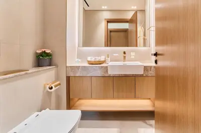 a bathroom with a sink and a toilet and a mirror at Modern 2BR Retreat in JVC with Private Pool Balcony in Dubai