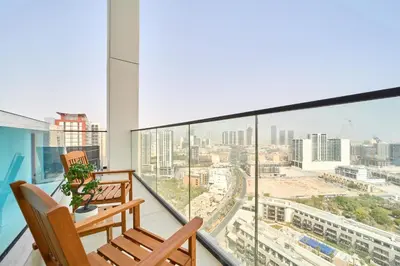 a balcony with a view of a city at Modern 2BR Retreat in JVC with Private Pool Balcony in Dubai