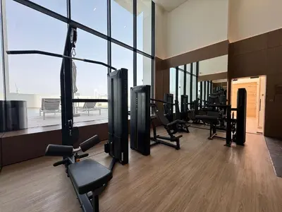 a gym with treadmills and cardio equipment in a building at Modern 2BR Retreat in JVC with Private Pool Balcony in Dubai