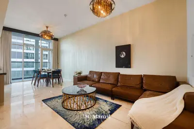 a living room with a couch and a table at Luxury 2BR Apartment in Business Bay with Pool, Sauna and Burj Khalifa View in Dubai