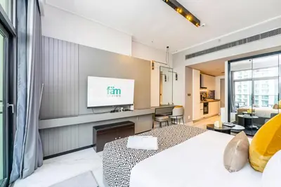 a bedroom with a bed and a flat screen tv at FAM Living - Urban Stays - MAG318, 5 mins to Burj Khalifa in Dubai