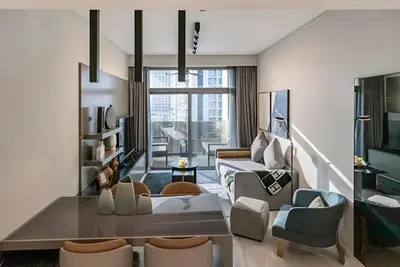 a living room with a couch and a table at FAM Living - Urban Stays - MAG318, 5 mins to Burj Khalifa in Dubai