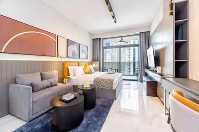 a hotel room with a bed and a couch at FAM Living - Urban Stays - MAG318, 5 mins to Burj Khalifa in Dubai