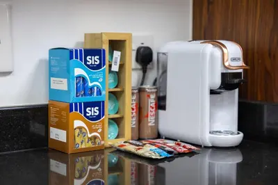 a counter top with boxes of cereal and a coffee maker at Serene 2BR Burj Khalifa & Fountain View in Dubai