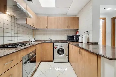 a kitchen with a washer and dryer in it at Cozy 1BR Apartment in Dubai Marina with City Views in Dubai