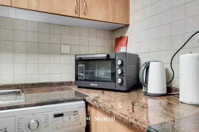 a microwave sitting on a counter in a kitchen at Cozy 1BR Apartment in Dubai Marina with City Views in Dubai