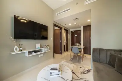 a living room with a couch and a tv at Airstay - Cozy 1BR - Canal View - Business Bay - Monthly Offer Available in Dubai