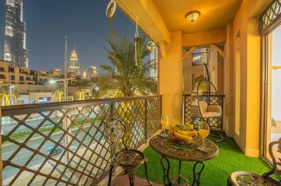a balcony with a table and chairs with a view of the city at Zaafaran 5 Full Burj View Downtown Luxury Stay in Dubai