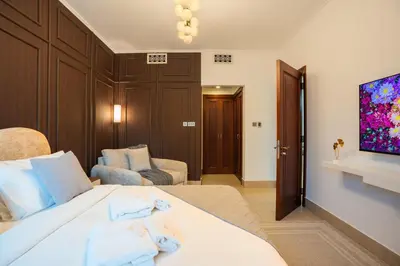 a hotel room with a bed and a tv at Zaafaran 5 Full Burj View Downtown Luxury Stay in Dubai