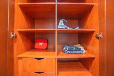 a wooden closet with wooden shelves and a red box at Zaafaran 5 Full Burj View Downtown Luxury Stay in Dubai