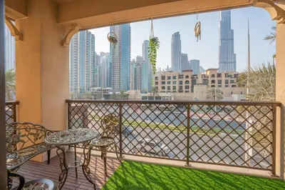 a balcony with a table and a view of the city at Zaafaran 5 Full Burj View Downtown Luxury Stay in Dubai