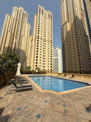 a swimming pool in a city with tall buildings at Pistachio Pecan - Sea View - Luxury 1 BR Apartment at JBR Beach in Dubai