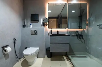 a bathroom with a toilet and a sink and a shower at JLT Laguna Tower Spacious Studio with Lake View for 4 Guests in Dubai
