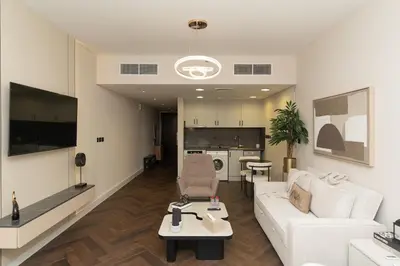 a living room with a white couch and a table at JLT Laguna Tower Spacious Studio with Lake View for 4 Guests in Dubai