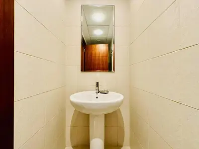 a bathroom with a white sink and a mirror at Modern Apartment standpoint near dubai opera in Dubai