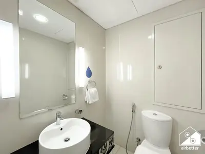 a white bathroom with a sink and a mirror at Elegant 2-Bed Retreat, Stunning Downtown Views in Dubai
