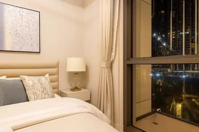 a bedroom with a bed and a window at Luxury Apartment - Downtown in Dubai