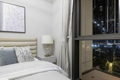 a bedroom with a bed and a window with a view at Luxury Apartment - Downtown in Dubai