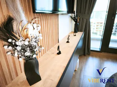 a room with a vase of flowers on a wall at Modern 6 sleeper JVC Rooftop pool, tennis court 10 min to Marina in Dubai