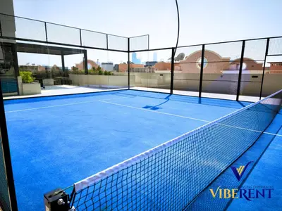 a tennis court with a net on top of it at Modern 6 sleeper JVC Rooftop pool, tennis court 10 min to Marina in Dubai