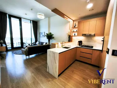 a kitchen and a living room with a couch at Modern 6 sleeper JVC Rooftop pool, tennis court 10 min to Marina in Dubai
