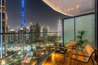 a room with a view of a city at night at Deluxe, Elegant - 3BR - DT - Burj Khalifa View in Dubai