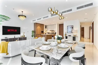 a dining room with a table and chairs at Deluxe, Elegant - 3BR - DT - Burj Khalifa View in Dubai
