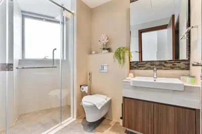a bathroom with a toilet and a sink and a shower at Deluxe, Elegant - 3BR - DT - Burj Khalifa View in Dubai