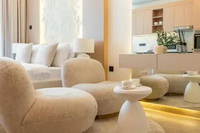 a living room with two chairs and a couch at New Studio Aura JVC Pool Gym Sauna Padel court in Dubai