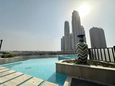 a vase sitting next to a pool in a city at Infinity Pool - 6 minutes to Dubai Mall - Luxury in Dubai