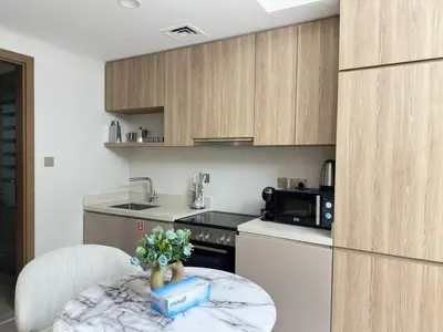 a kitchen with a table with a box on it at Infinity Pool - 6 minutes to Dubai Mall - Luxury in Dubai