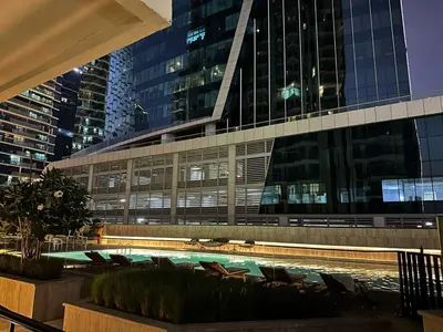 a building with a swimming pool in front of a building at Infinity Pool - 6 minutes to Dubai Mall - Luxury in Dubai