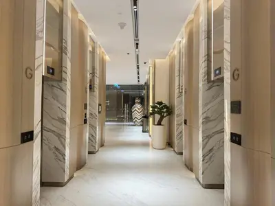 a hallway in a building with a person walking down it at Infinity Pool - 6 minutes to Dubai Mall - Luxury in Dubai