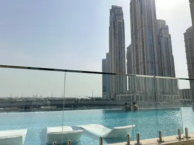 a swimming pool in a city with buildings at Infinity Pool - 6 minutes to Dubai Mall - Luxury in Dubai