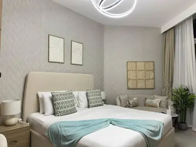 a bedroom with a large bed and a couch at Infinity Pool - 6 minutes to Dubai Mall - Luxury in Dubai
